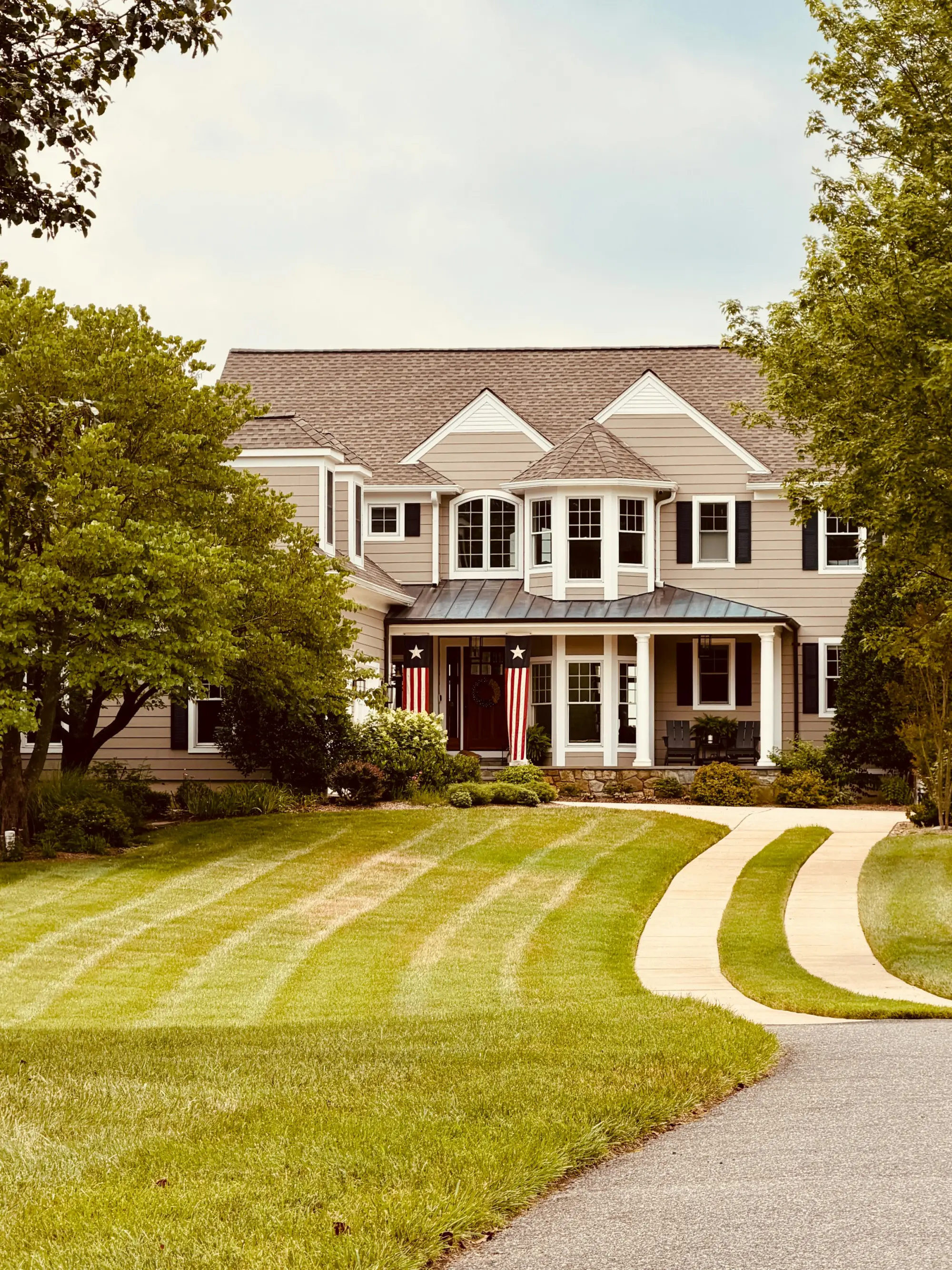 Striped, freshly mowed lawn in front of a home