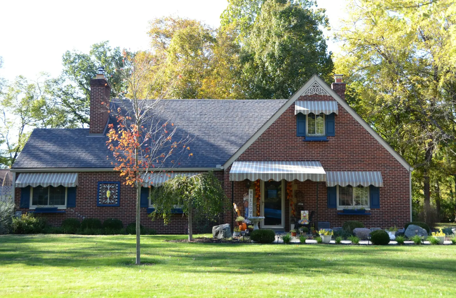 Neatly mowed front lawn at a brick home